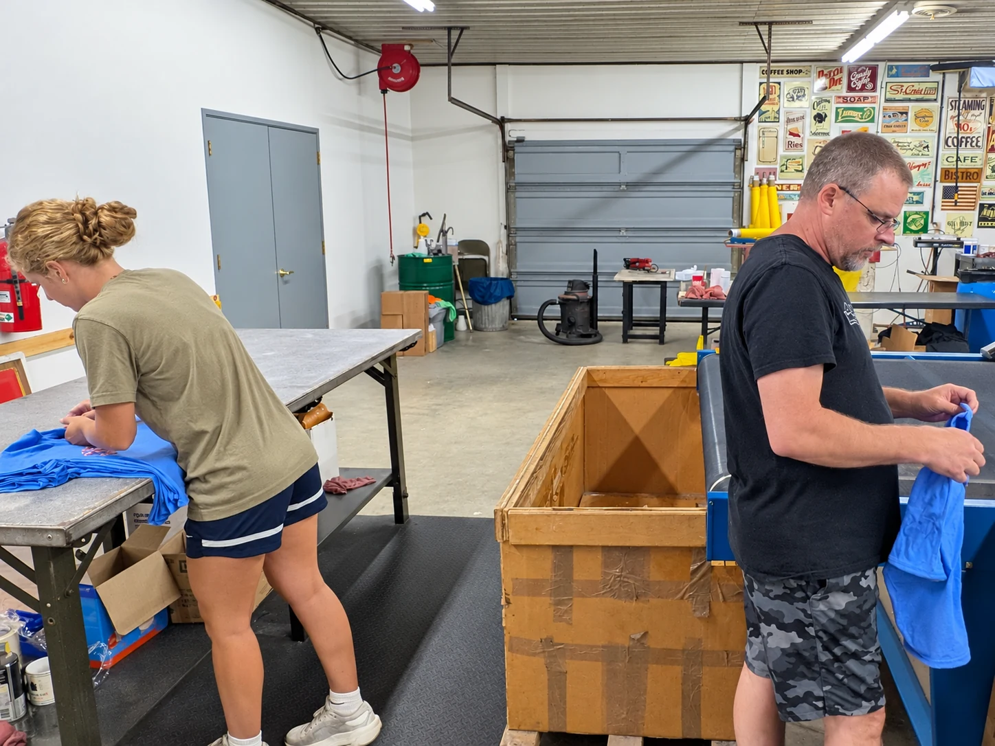 Edited photo: Two Del Print employees preparing apparel orders at packing tables
