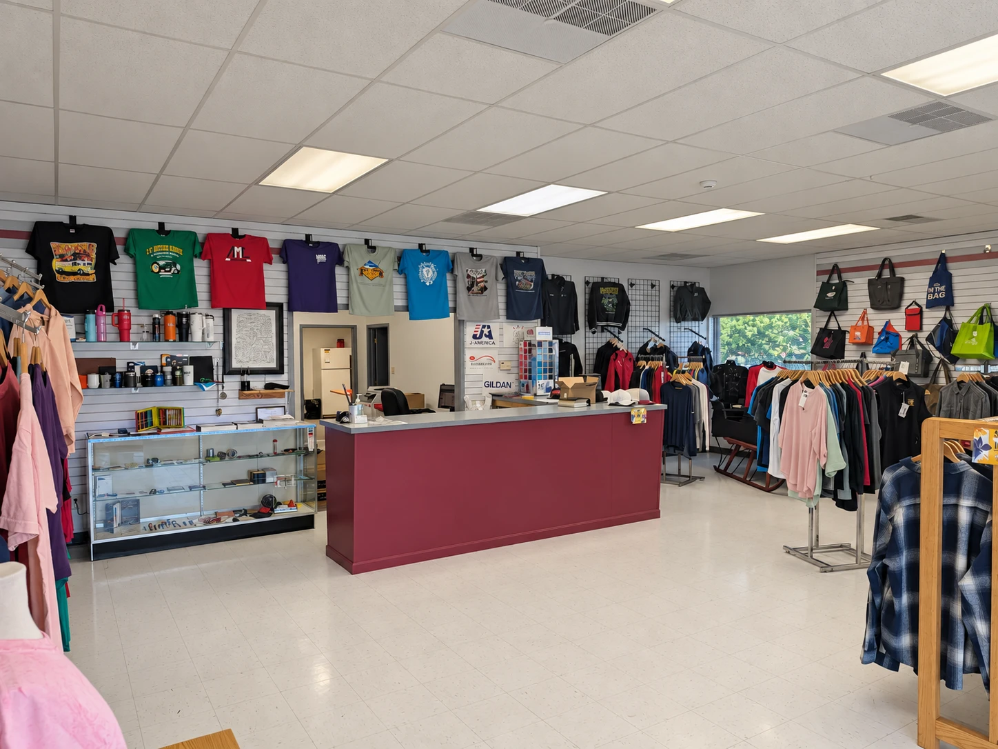 Edited photo of the counter, apparel racks, and displays in Del Print’s showroom